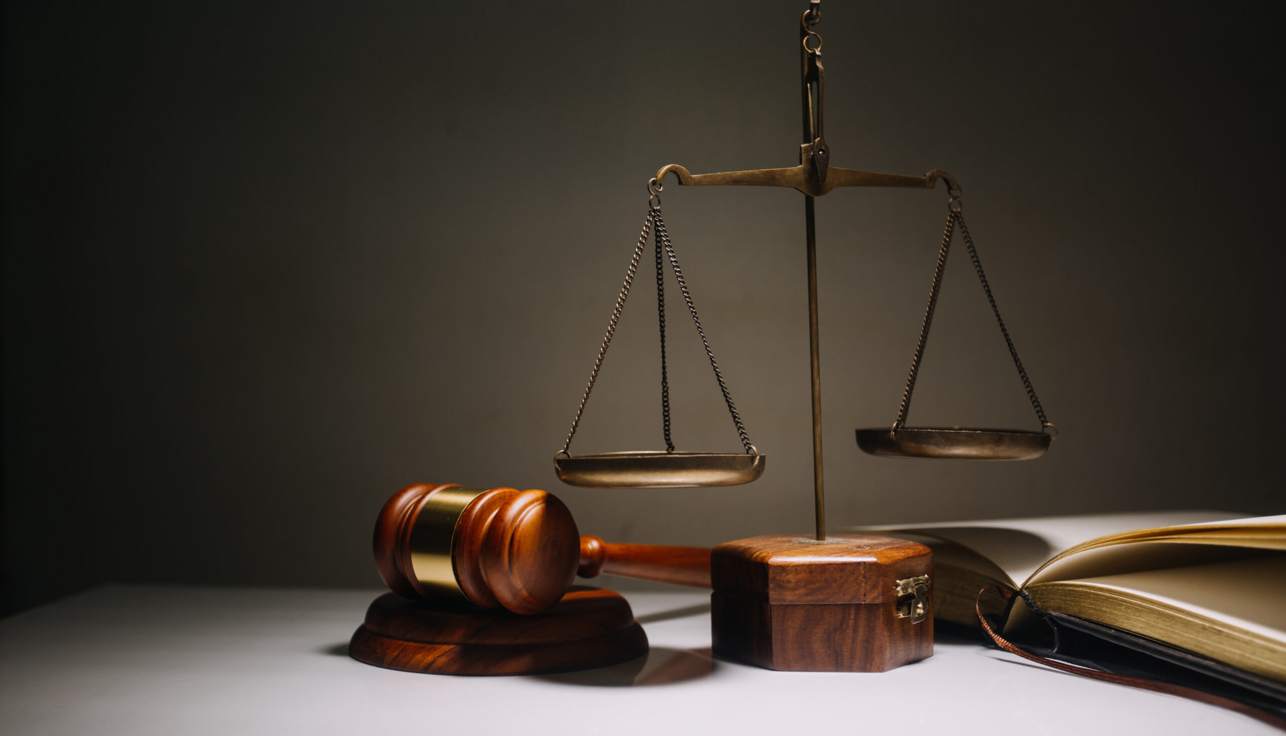 Business and lawyers discussing contract papers with brass scale