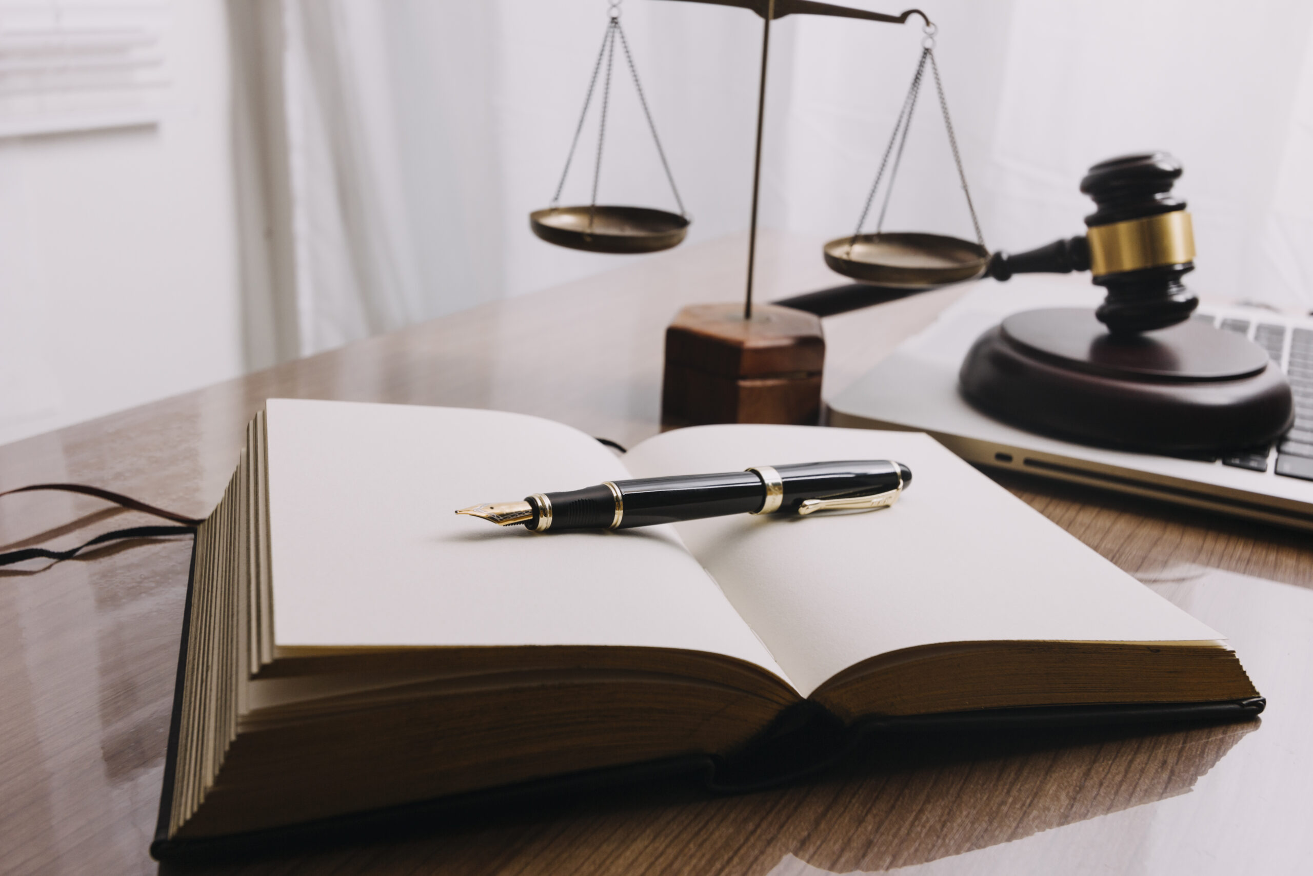 Business and lawyers discussing contract papers with brass scale