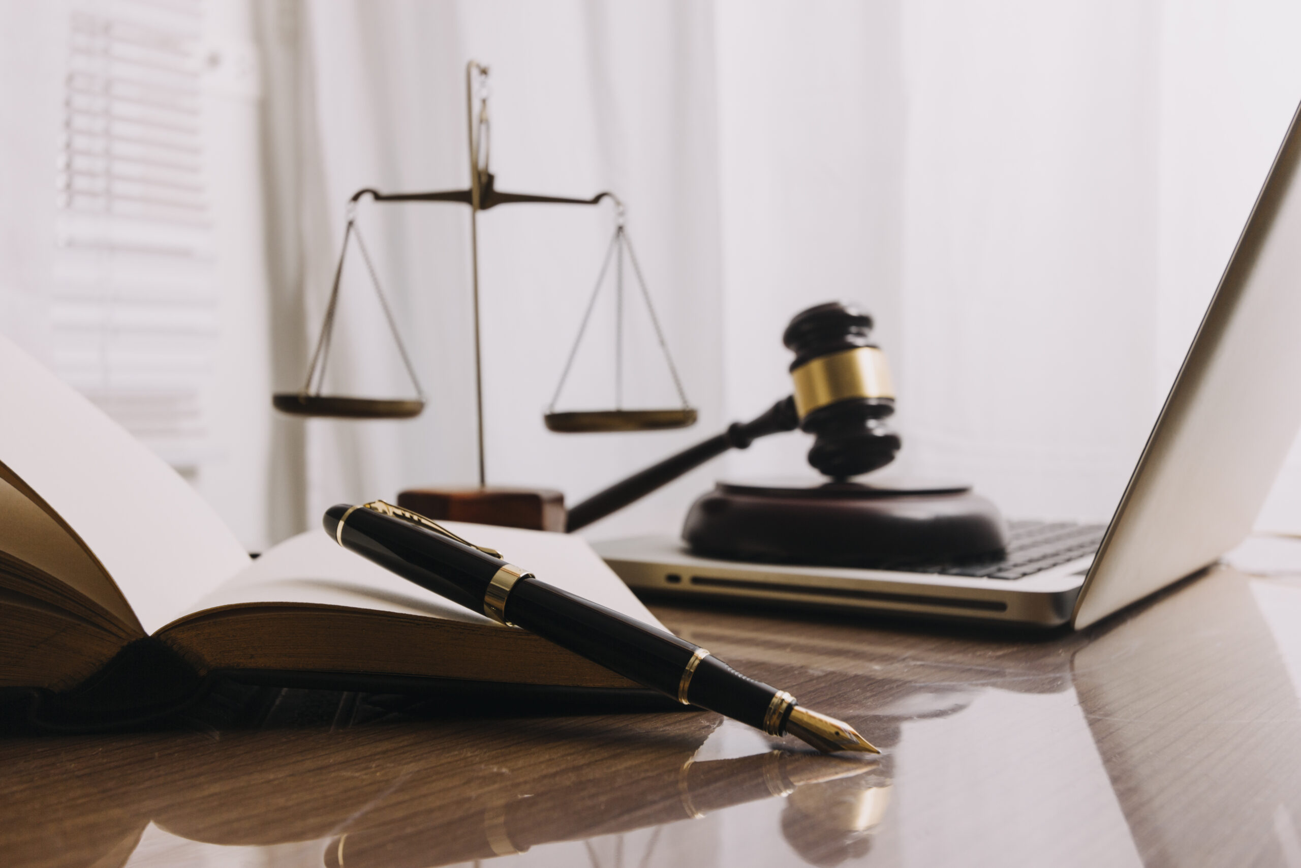 Business and lawyers discussing contract papers with brass scale